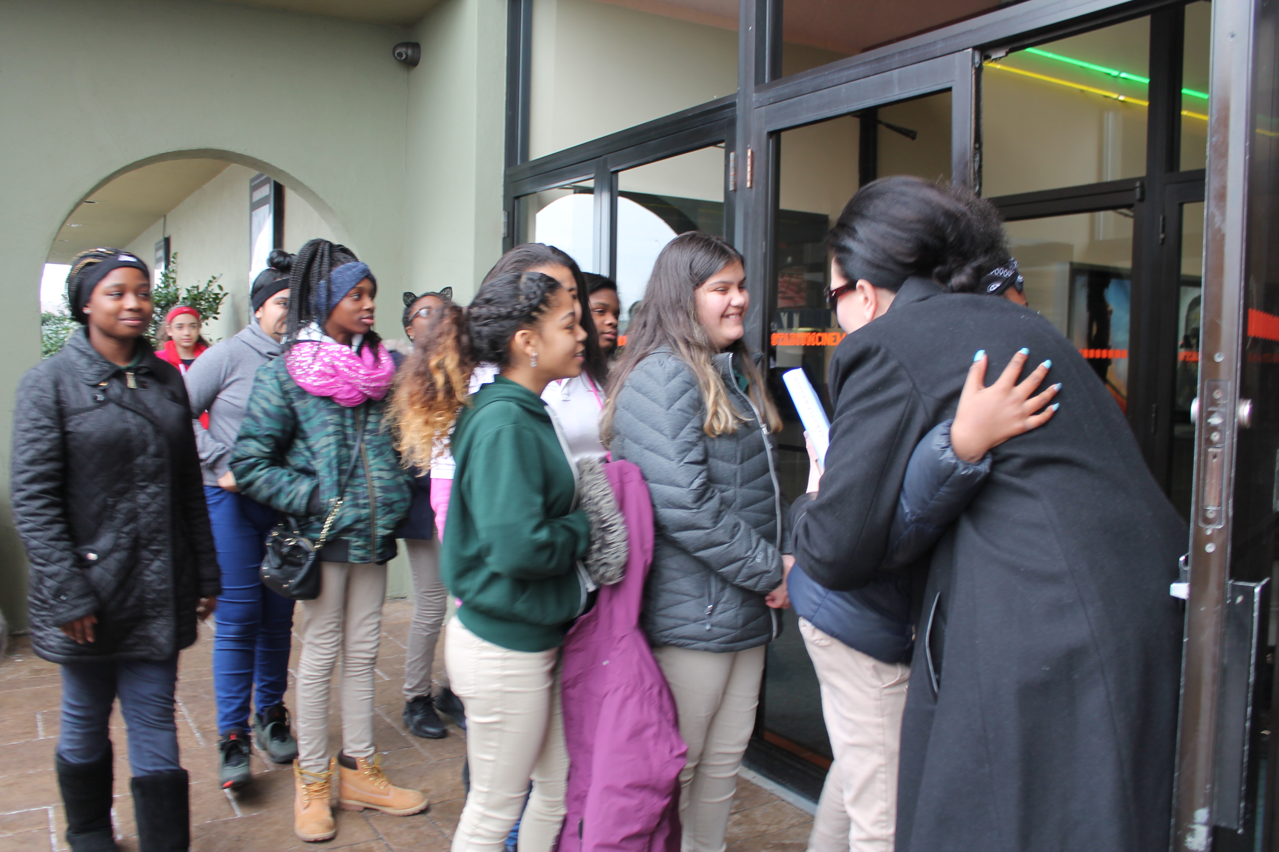 Kristine Garlisi greets each student before they enter the theater.